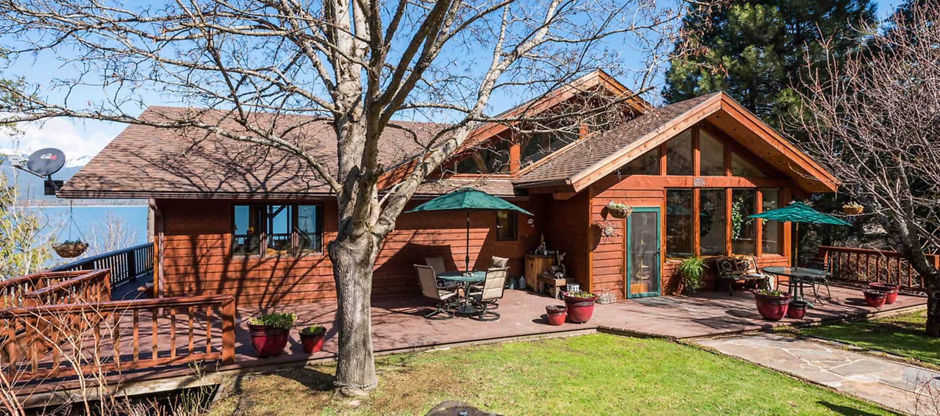 Redwood home tucked back in a quiet cove with 260+ feet of private Lake Pend Oreille frontage